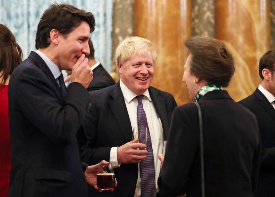 Canadian Prime Minister Justin Trudeau, British Prime Minister Boris Johnson and Princess Anne in conversation at Buckingham Palace.