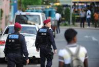 Policemen from the Special Command Operation (SOC) patrol the streets in Singapore's Little India on December 9, 2013