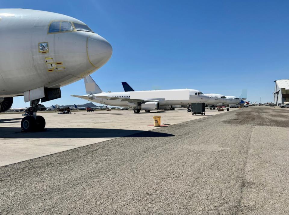 A row of aircraft undergoing re-configurations or heavy maintenance for between operators.