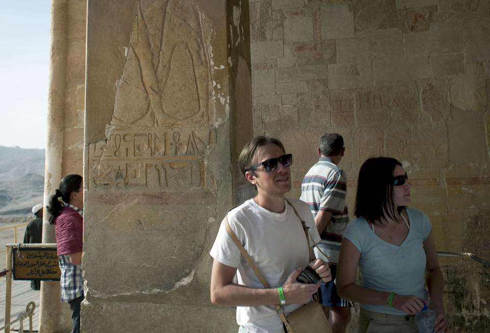 Foreign tourists visit the Hatshepsut Temple, in Luxor, Egypt, Wednesday, Feb. 27, 2013. Nineteen people were killed Tuesday in what appeared to be the deadliest hot air ballooning accident on record. The tragedy raised worries of another blow to the nation's vital tourism industry, decimated by two years of unrest since the 2011 revolution that toppled autocrat Hosni Mubarak. The southern city of Luxor has been hit hard, with vacant hotel rooms and empty cruise ships.(AP Photo/Nasser Nasser)