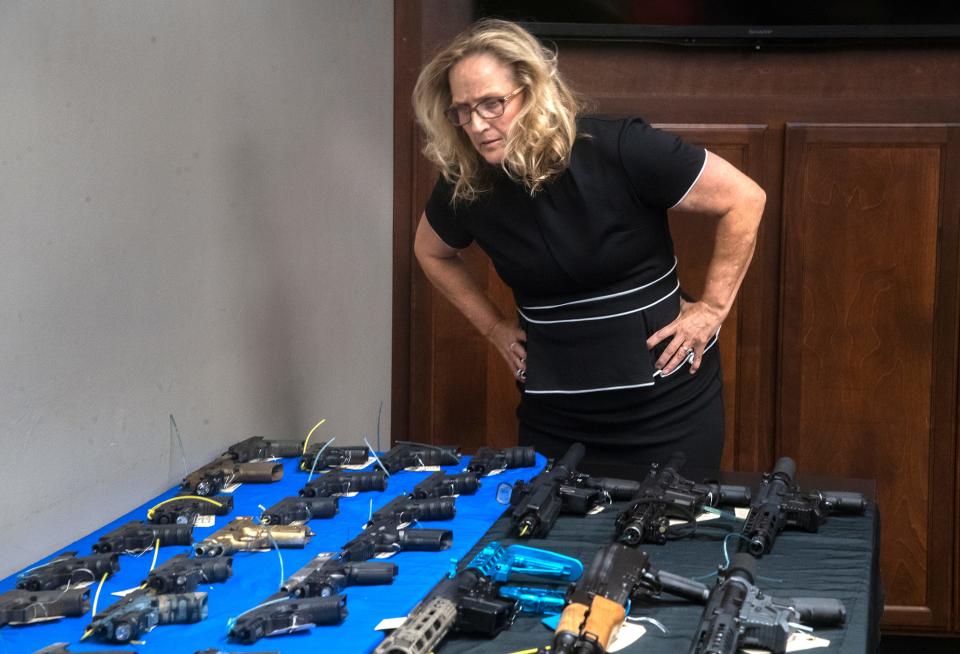 San Joaquin County District Attorney Tori Verber Salazar checks out a display of guns that were confiscated Stockton Police Operation Hybrid Havoc, which targeted guns and gangs.