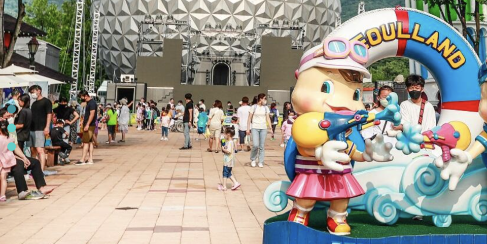 Seoul Land entrance has a big female mascot holding on to a gun