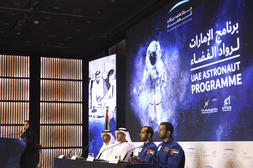 Emirati astronaut Sultan al-Neyadi, right, and astronaut Hazza al-Mansoori, second from right, brief journalists in Dubai, United Arab Emirates, Monday, Feb. 25, 2019. The UAE said on Monday it will send either astronaut al-Mansoori or al-Neyadi to the International Space Station on Sept. 25 aboard a Russian Soyuz rocket. The UAE has a fledgling space program with big ambitions. (AP Photo/Jon Gambrell)