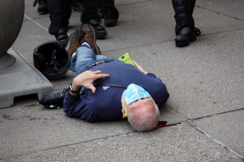 Martin Gugino lays on the ground after he was shoved by two Buffalo, New York, police officers during a protest against the death in Minneapolis police custody of George Floyd in Buffalo, New York