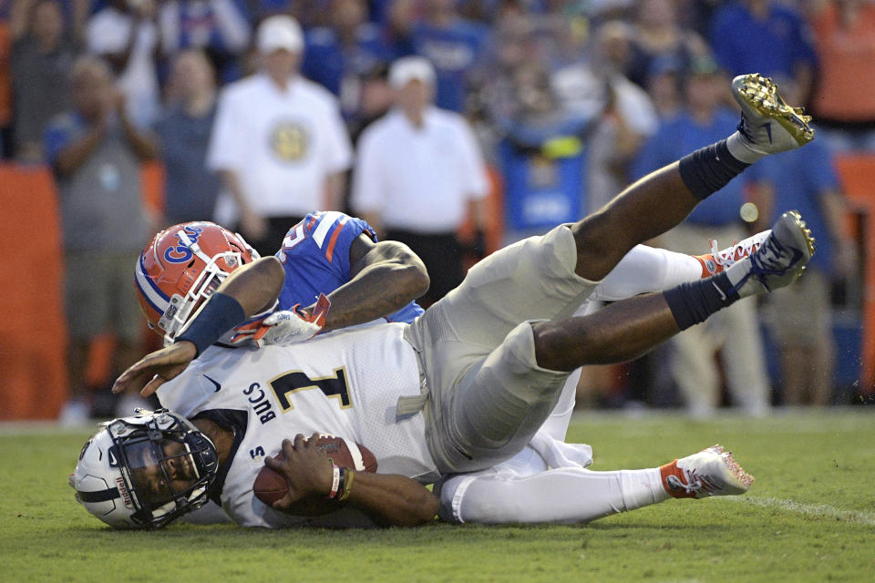 Charleston Southern quarterback London Johnson (1) is sacked by Florida defensive back Chauncey Gardner-Johnson (23) for a 7-yard loss during the first half of an NCAA college football game Saturday, Sept. 1, 2018, in Gainesville, Fla. (AP Photo/Phelan M. Ebenhack)