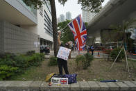 A pro-democracy supporter waves a British flag outside a court in Hong Kong Friday, April 16, 2021. Seven of Hong Kong’s leading pro-democracy advocates, including 82-year-old veteran activist Martin Lee and pro-democracy media tycoon Jimmy Lai, are expected to be sentenced Friday for organizing a march during the 2019 anti-government protests that triggered an overwhelming crackdown from Beijing.(AP Photo/Kin Cheung)