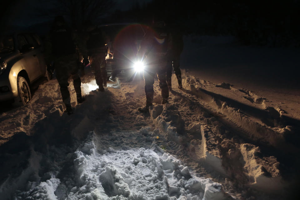 Bosnian police return from chasing a suspected serial killer in the village of Medvjedice 30 kms south of Sarajevo, Bosnia, Tuesday, Feb. 12, 2019. Bosnia police on Tuesday shot and killed the country's most-wanted fugitive, who had been sought in the slayings of a police officer and another person, after a huge manhunt. Edin Gacic died after a shootout with police near the capital Sarajevo, police said. (AP Photo/Amel Emric)