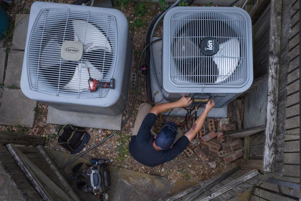 Geoff Bell, a HVAC technician with Texas Pride Air Conditioning and Heating, tests the refrigerant levels in an air conditioning unit during a heat wave in Houston, Texas, U.S., August 24, 2023.