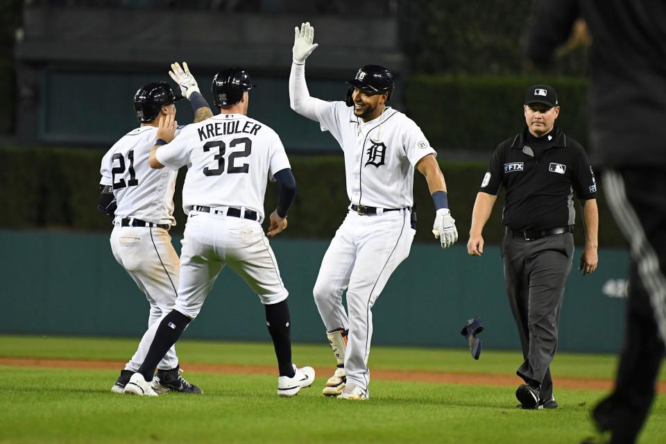 Detroit Tigers right fielder Victor Reyes (22)  celebrates with shortstop Javier Baez (28)  and third baseman Ryan Kreidler (32) after hitting a sacrifice fly to end the 10th inning at Comerica Park in Detroit on Friday, Sept. 16, 2022.