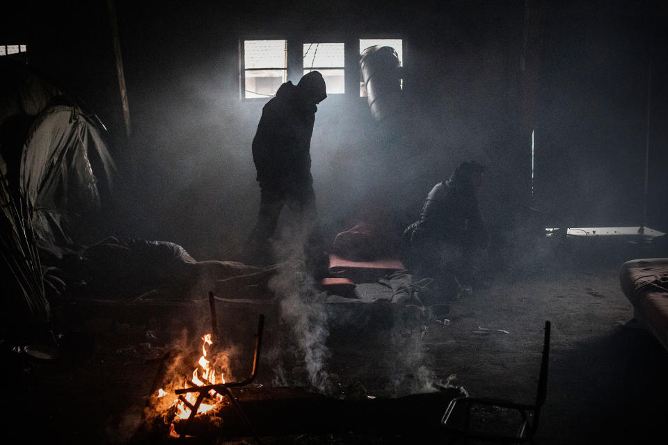 <p>An Afghan refugee walks near his tent inside an abandoned warehouse near the Central train station in Belgrade, Serbia, Feb. 2017. (Manu Brabo/MeMo) </p>