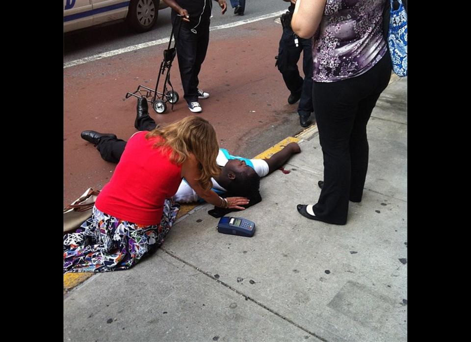 This photo posted to an Instagram account belonging to a person identified as mr_mookie, an eyewitness at the scene, shows a victim of a shooting being tended to by pedestrians outside the Empire State Building in New York, Friday, Aug. 24, 2012. The identity or condition of the victim was not immediately known. Law enforcement officials in New York City say at least four people have been shot outside the Empire State Building in violence that stemmed from a workplace dispute, and that the gunman has been killed by police. The shooting happened at about 9 a.m. Friday at 34th Street and Fifth Avenue. (AP Photo/mr_mookie via Instagram)