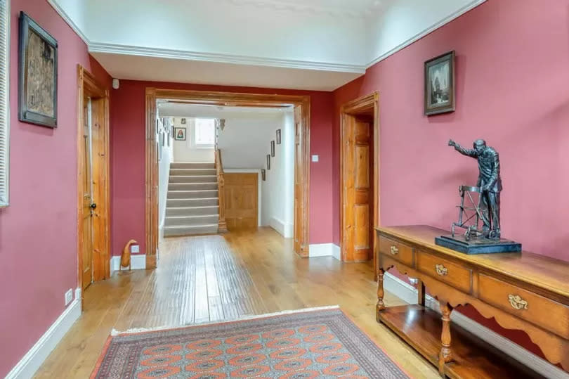 A statue of Captain Sir Tom Moore sits in the hallway of his former home.