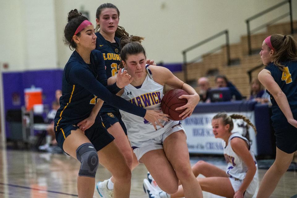 Warwick's Paige Girardi holds back Lourdes defenders as she drives to the net during the Section 9 BCANY Coaches vs. Cancer tournament at Monroe-Woodbury High School in Central Valley on Saturday, January 7, 2023.