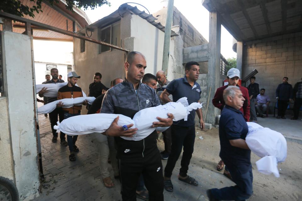 Palestinians carry the members of the Hijazi family who were killed in an Israeli strike in Rafah (Copyright 2023 The Associated Press. All rights reserved.)