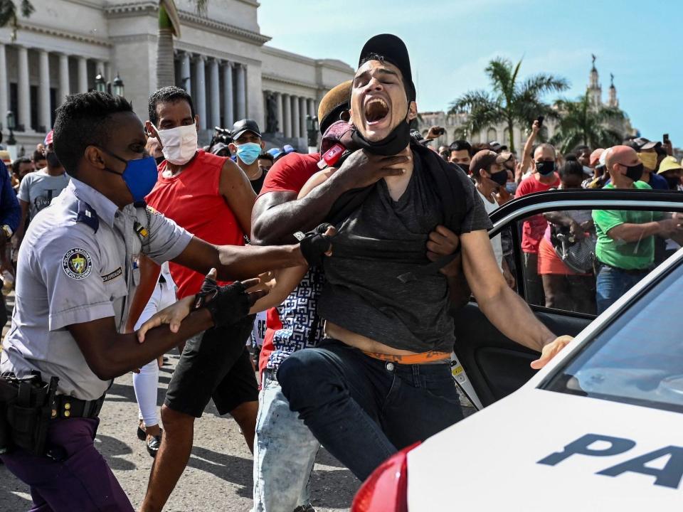 man is arrested during a demonstration against the government of Cuban President Miguel Diaz-Canel in Havana, on July 11, 2021.