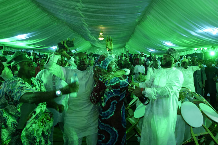 Supporters of Presidential candidate Bola Tinubu of the All Progressives Congress celebrate the victory of their candidate in the presidential elections at the Party's campaign headquarters in Abuja, Nigeria, Wednesday, March 1, 2023. Election officials declared ruling party candidate Tinubu the winner of Nigeria's presidential election with the two leading opposition candidates already demanding a re-vote in Africa's most populous nation. (AP Photo/Ben Curtis)