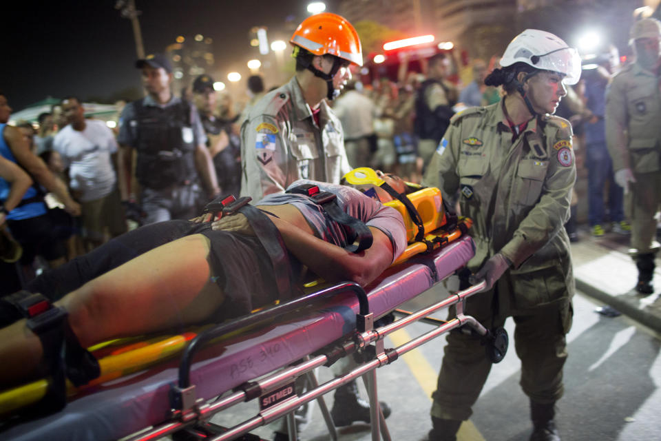 <p>Firefighters carry a woman on a stretcher after a car drove into the crowded seaside boardwalk along Copacabana beach in Rio de Janeiro, Brazil, Thursday, Jan. 18, 2018. (Photo: Silvia Izquierdo/AP) </p>