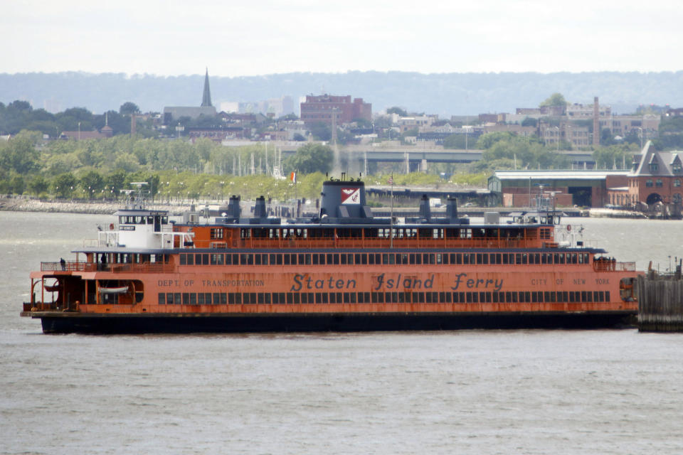 FILE — The Staten Island Ferry "John F. Kennedy" docks in New York, May 9, 2010. “Saturday Night Live” comics Colin Jost and Pete Davidson have purchased a decommissioned Staten Island Ferry boat with plans to turn it into New York’s hottest club. Jost and Davidson teamed up with comedy club owner Paul Italia on Wednesday, Jan. 19, 2022 winning for $280,100 bid for the John F. Kennedy. (AP Photo/Seth Wenig, File)