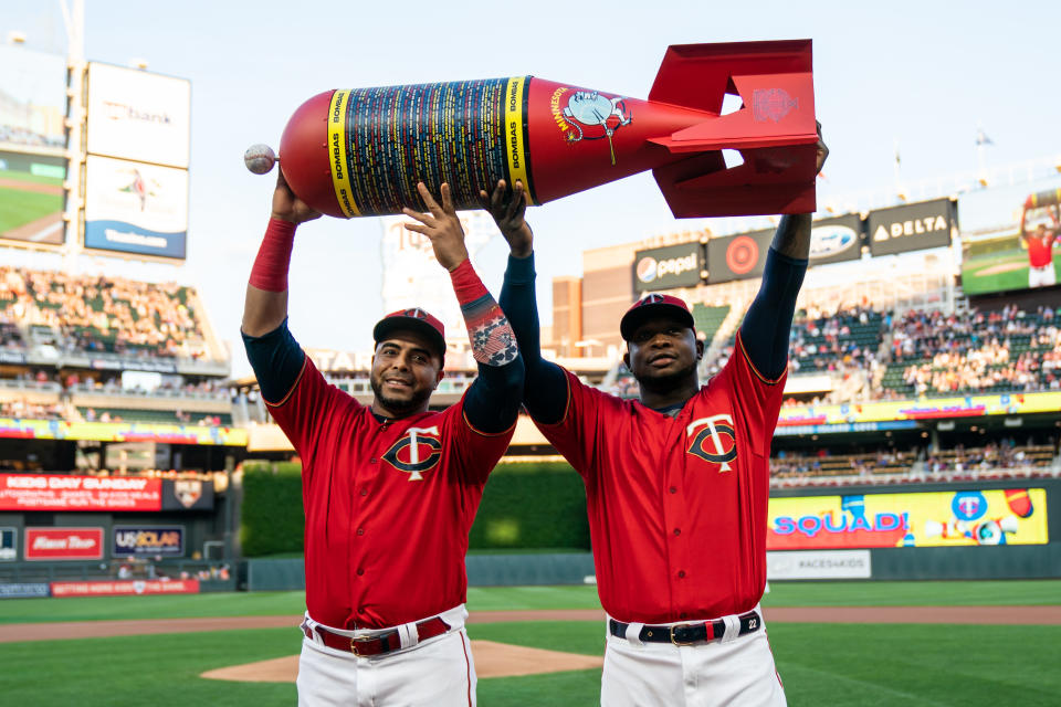 MINNEAPOLIS, MN - SEPTEMBER 06: Nelson Cruz #23 and Miguel Sano #22 of the Minnesota Twins are presented an award for setting the MLB single season home run record prior to the game against the Cleveland Indians on September 6, 2019 at the Target Field in Minneapolis, Minnesota. The Indians defeated the Twins 6-2. (Photo by Brace Hemmelgarn/Minnesota Twins/Getty Images)