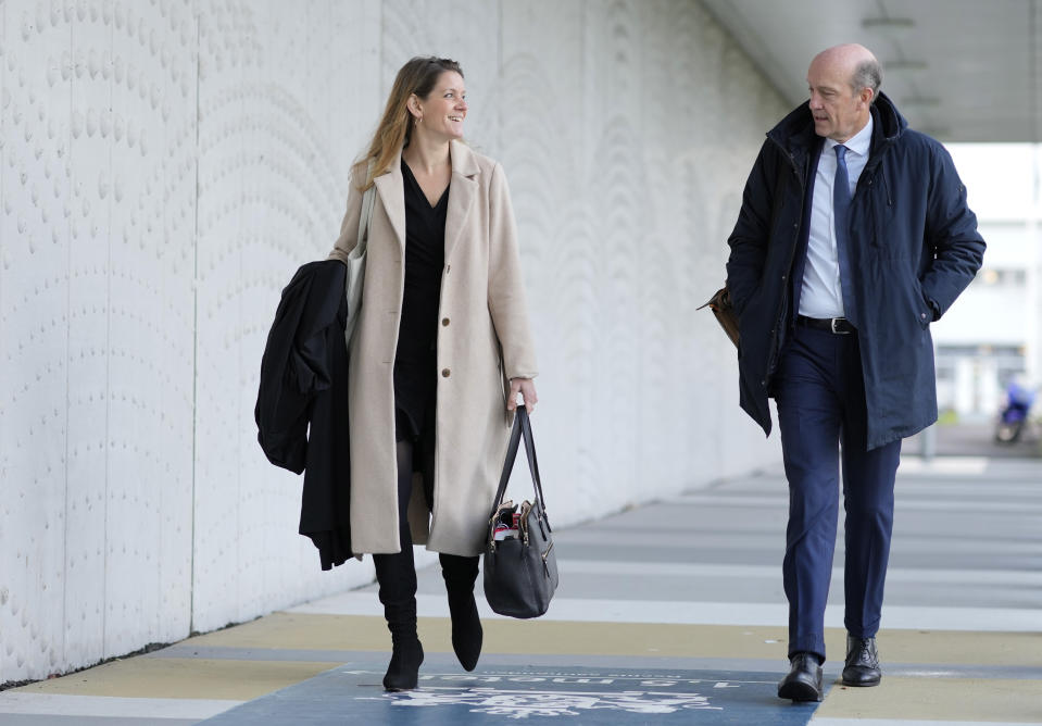 Lawyers for relatives, Sabine ten Doesschate, left, and Boudewijn van Eijck arrive outside the court for the ongoing trial and criminal proceedings regarding the downing of Malaysia Airlines flight MH17, at the high security court at Schiphol airport, near Amsterdam, Netherlands, Monday Dec. 20, 2021. Prosecutors are scheduled to begin explaining evidence and their case to judges Monday in the murder trial of three Russians and a Ukrainian charged with involvement in downing Malaysia Airlines flight MH17 over eastern Ukraine in 2014, killing all 298 passengers and crew. (AP Photo/Peter Dejong)