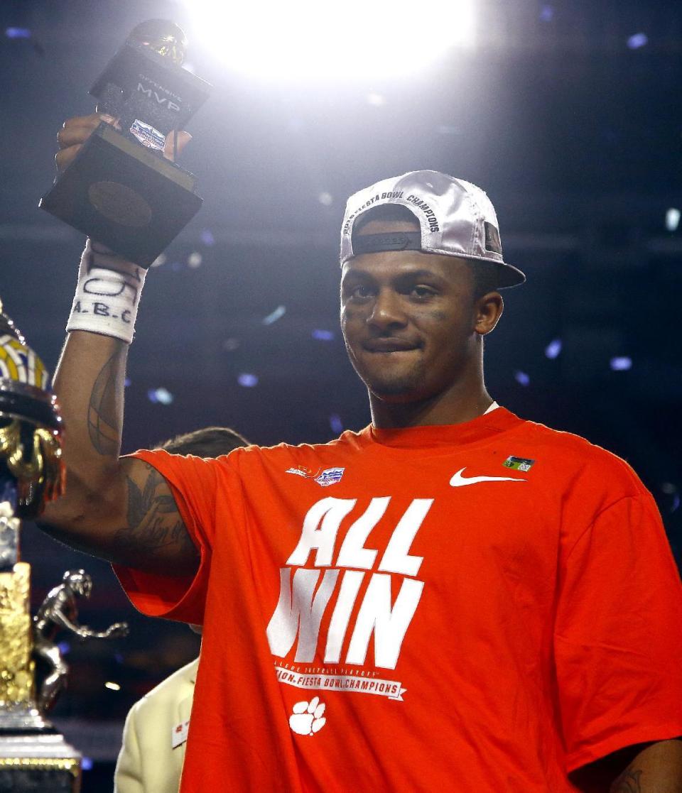 Clemson quarterback Deshaun Watson holds the offensive player of the game trophy after the Fiesta Bowl NCAA college football playoff semifinal, against Ohio State, Saturday, Dec. 31, 2016, in Glendale, Ariz. Clemson won 31-0 to advance to the BCS championship game on Jan. 9 against Alabama. (AP Photo/Ross D. Franklin)
