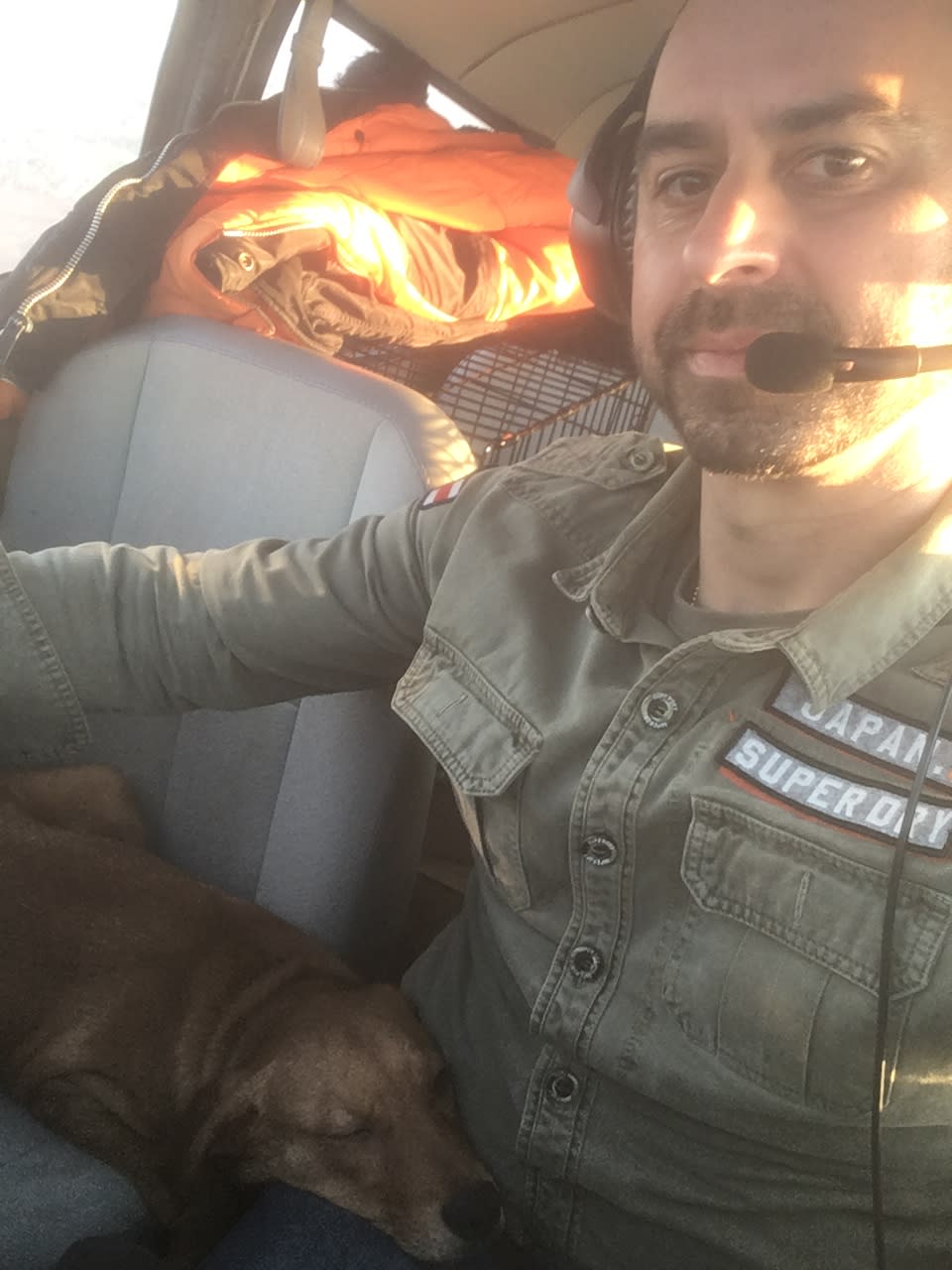A dog relaxes in Eduard Seitan's lap while he flies a plane. (Courtesy of Eduard Seitan)