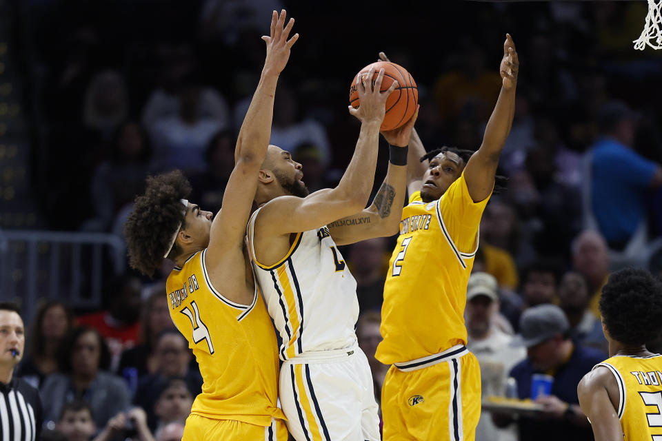 Toledo forward Setric Millner Jr. (4) shoots against Kent State forward Chris Payton (4) and guard Malique Jacobs (2) during the first half of an NCAA college basketball game for the championship of the Mid-American Conference Tournament, Saturday, March 11, 2023, in Cleveland. (AP Photo/Ron Schwane)