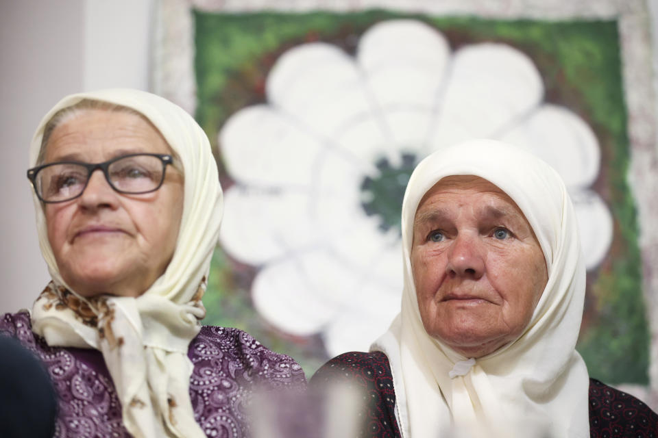 Mejra Djogaz, right, member of the association Mothers of Srebrenica watches the United Nations General Assembly session where voting on a draft resolution declaring July 11 the International Day of Reflection and Commemoration of the 1995 genocide in Srebrenica takes place, in Potocari, Bosnia, Thursday, May 23, 2024. (AP Photo/Armin Durgut)