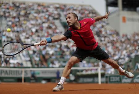 Darcis returns the ball. REUTERS/Gonzalo Fuentes