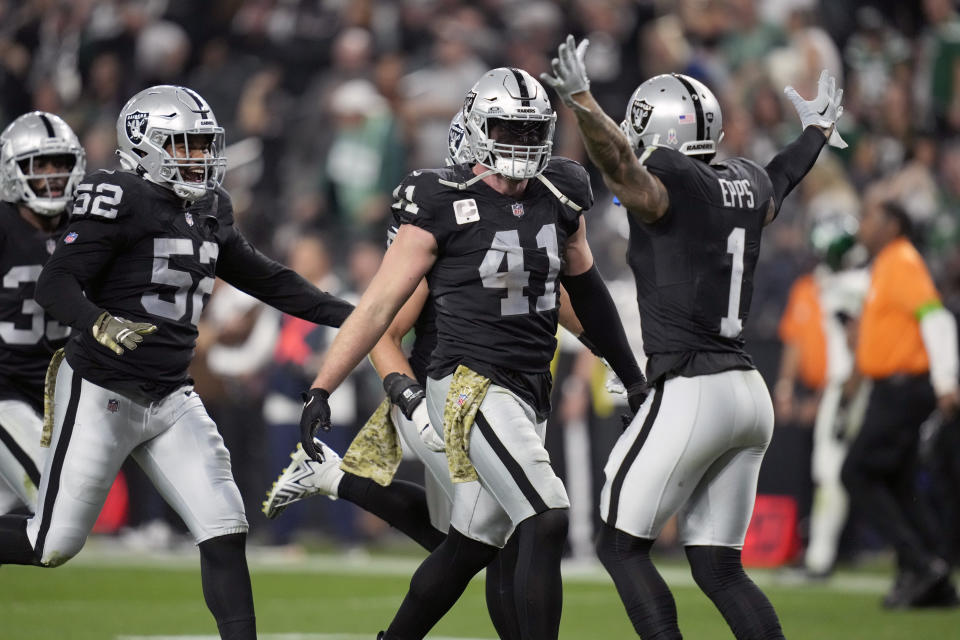 Las Vegas Raiders linebacker Robert Spillane (41) is congratulated by teammates after intercepting a pass during the second half of an NFL football game against the New York Jets Sunday, Nov. 12, 2023, in Las Vegas. (AP Photo/John Locher)