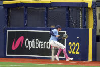 Tampa Bay Rays' Josh Lowe reaches for a hit by New York Yankees' Anthony Volpe that resulted in a triple during the first inning of a baseball game Sunday, May 12, 2024, in St. Petersburg, Fla. (AP Photo/Mike Carlson)