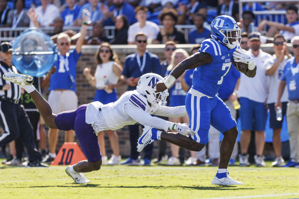 Duke's Jordan Waters (7) carries the ball past Northwestern's Devin Turner, left, during the first half of an NCAA college football game in Durham, N.C., Saturday, Sept. 16, 2023. (AP Photo/Ben McKeown)