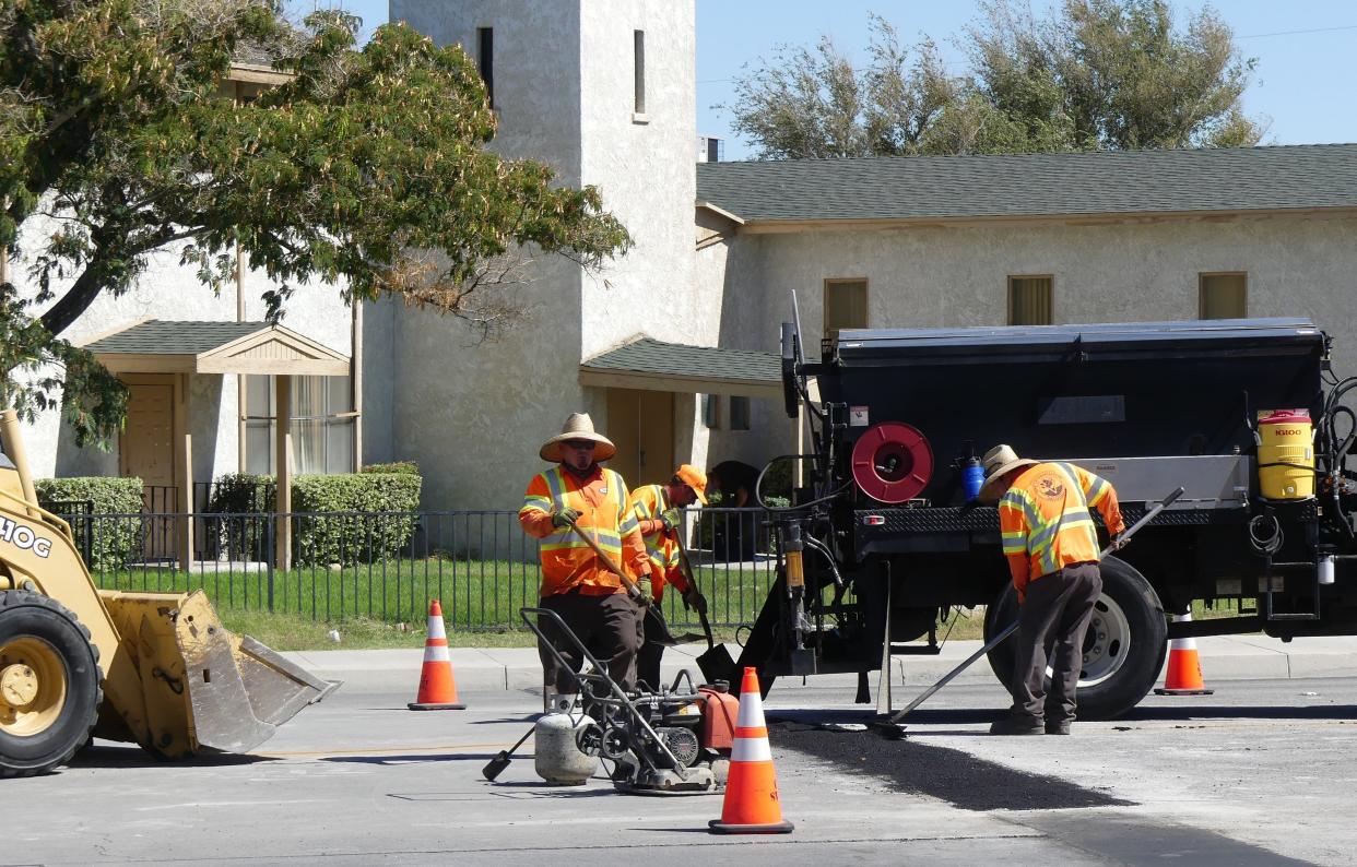 A City of Victorville Public Works crew performs road maintenance Wednesday afternoon on La Paz Drive.