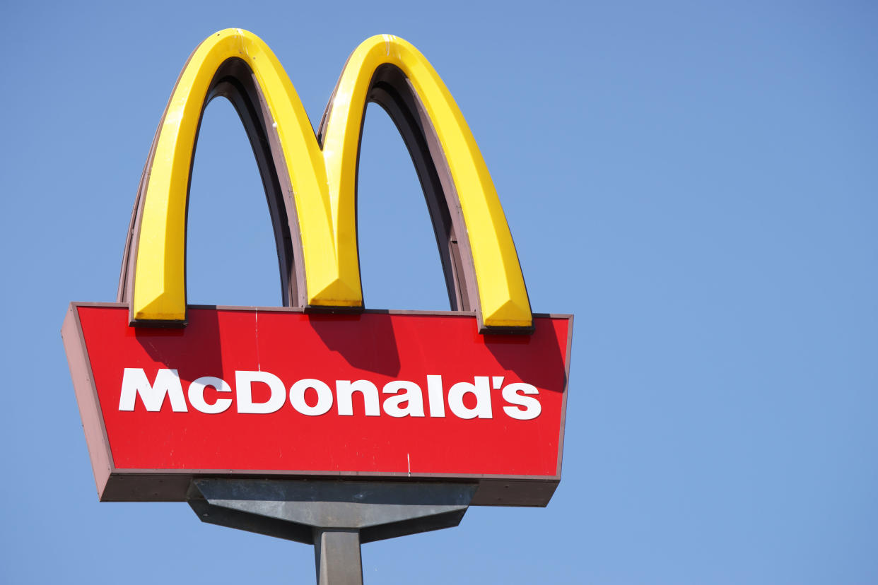 Ljubljana, Slovenia - September 3, 2011: Close-up of McDonalds outdoor sign with  typical rounded yellow M letter against cloudless blue sky. Sign is positioned on the left side of image.