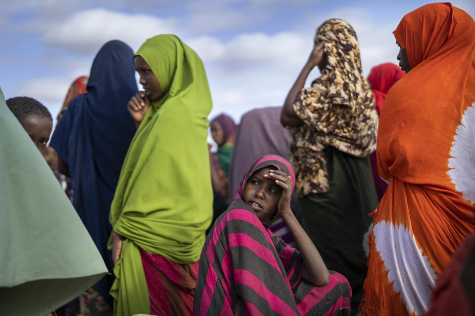 Somali women wait their turn to collect water at a camp for displaced people on the outskirts of Dollow, Somalia on Monday, Sept. 19, 2022. Elections, coups, disease outbreaks and extreme weather are some of the main events that occurred across Africa in 2022. Experts say the climate crisis is hitting Africa “first and hardest.” Kevin Mugenya, a senior food security advisor for Mercy Corps said the continent of 54 countries and 1.3 billion people is facing “a catastrophic global food crisis” that “will worsen if actors do not act quickly.” (AP Photo/Jerome Delay)