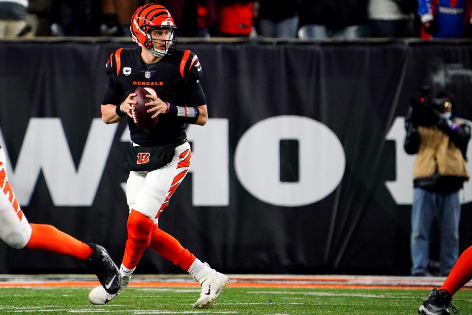 Cincinnati Bengals quarterback Joe Burrow (9) drops back to throw in the fourth quarter during an NFL AFC wild-card playoff game against the Las Vegas Raiders, Saturday, Jan. 15, 2022, at Paul Brown Stadium in Cincinnati.  The Cincinnati Bengals defeated the Las Vegas Raiders, 26-19 to win the franchise's first playoff game in 30 years.