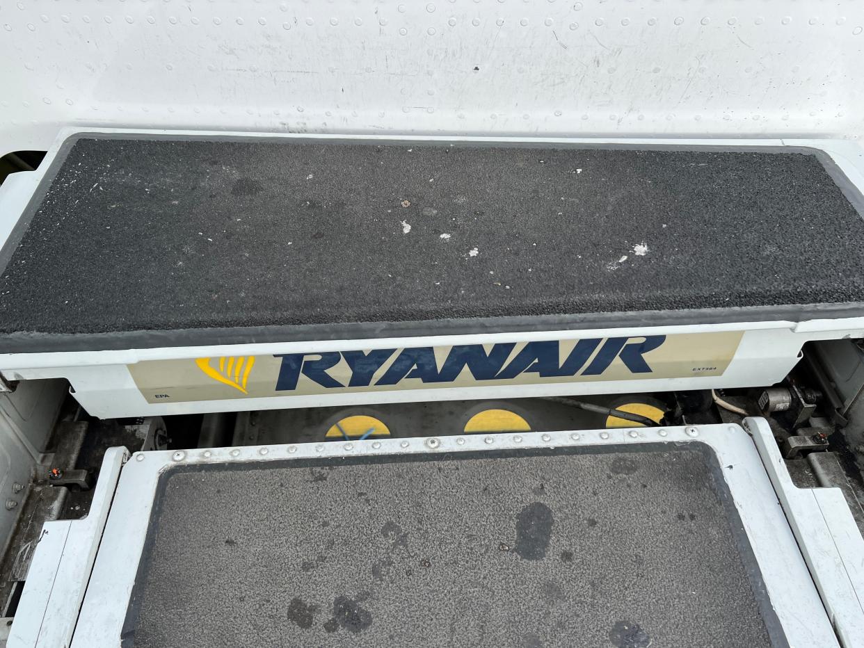 A close up of the stairs on a Ryanair Boeing 737-800 with the carrier's logo visible on a step