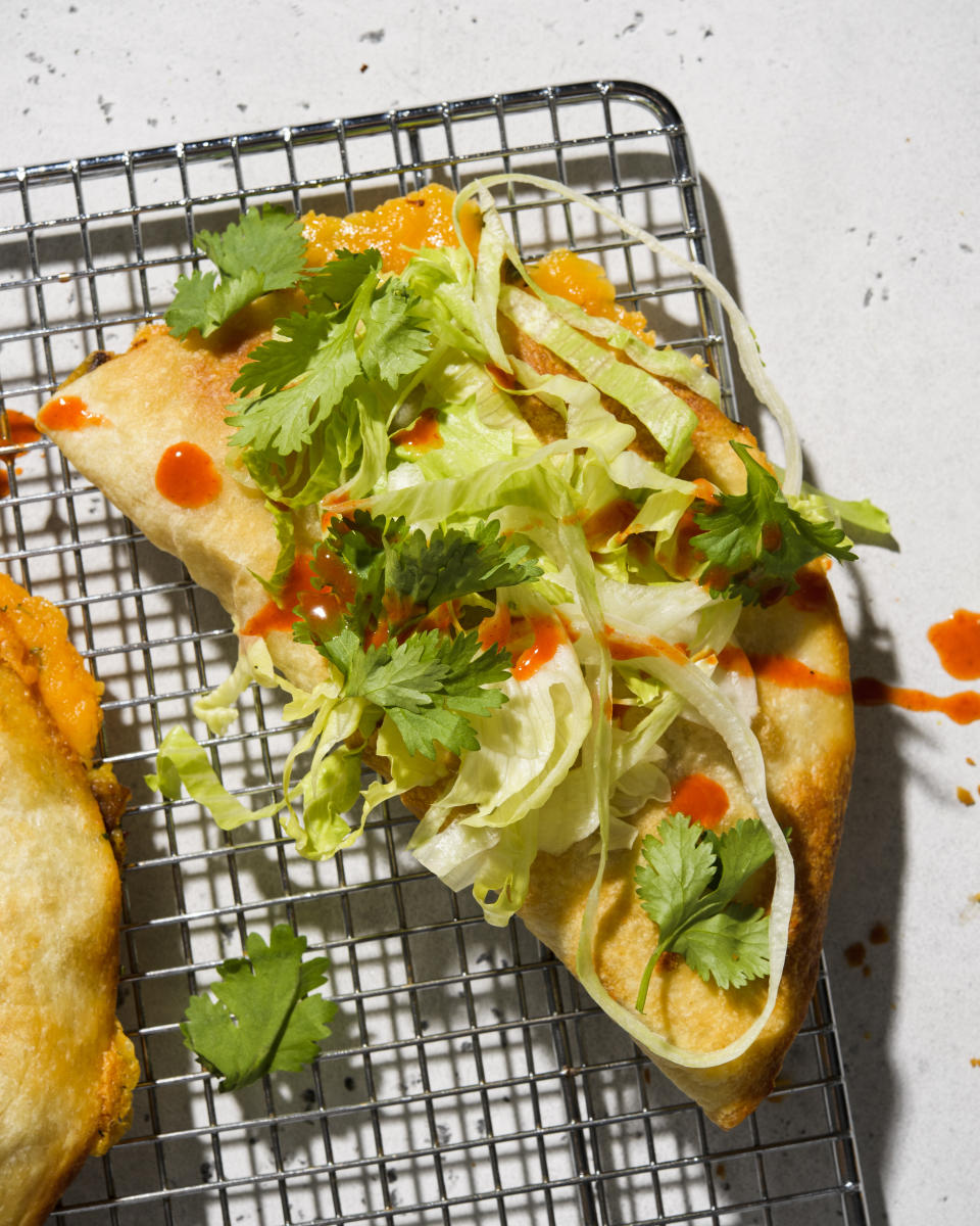This image released by Milk Street shows a recipe for oven-fried potato and cheese tacos dorados. (Milk Street via AP)