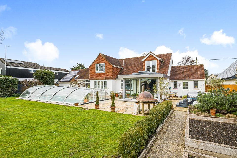 Solar panels help to heat this house and keep the water water in the outdoor pool.