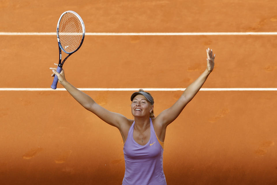 Maria Sharapova from Russia celebrates after winning the Madrid Open tennis tournament women's final match against Simona Halep of Rumania in Madrid, Spain, Sunday, May 11, 2014 . (AP Photo/Daniel Ochoa de Olza)