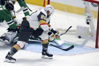 Vegas Golden Knights left wing William Carrier (28) scores past Dallas Stars goalie Jake Oettinger, back, during the first period of Game 6 of the NHL hockey Stanley Cup Western Conference finals Monday, May 29, 2023, in Dallas. (AP Photo/Gareth Patterson)