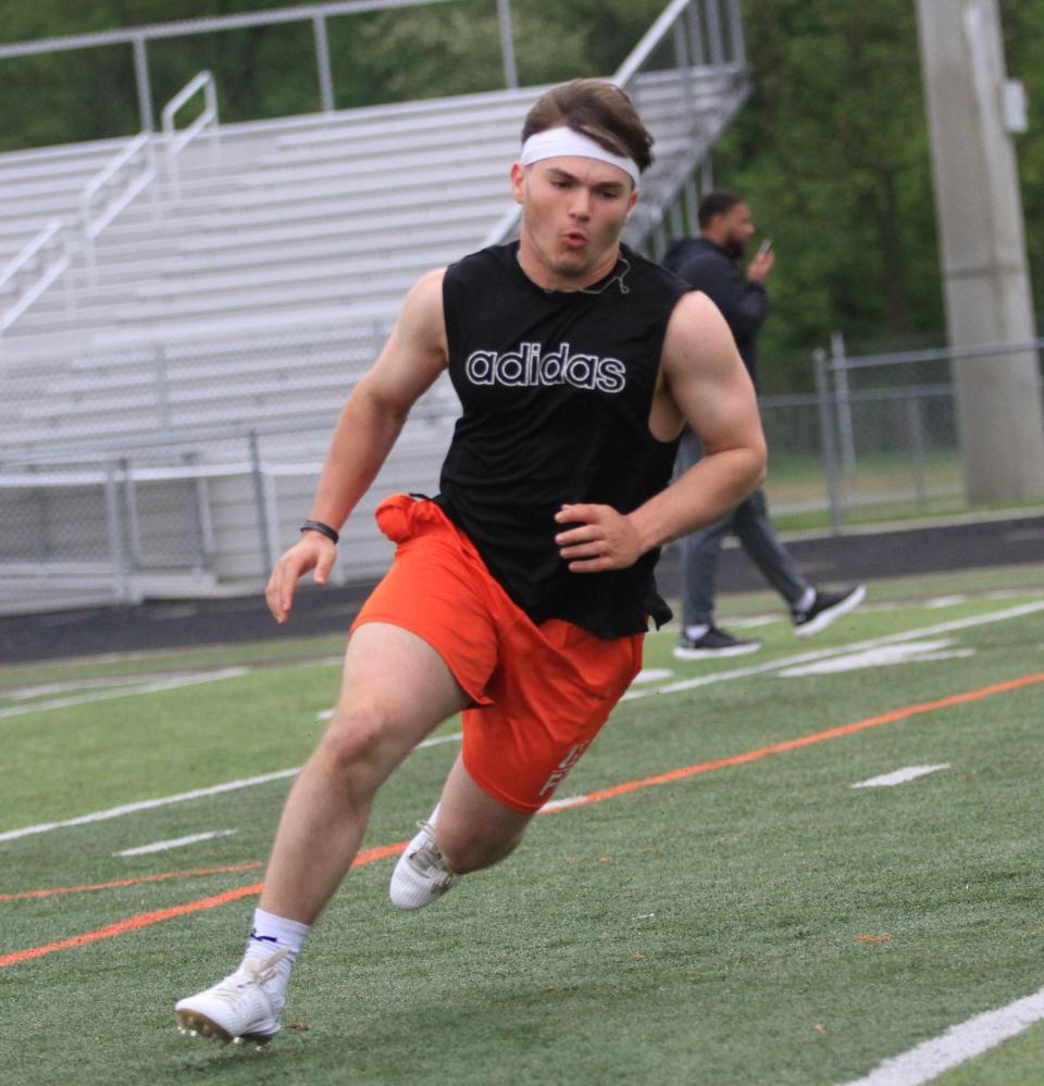 Heath's Connor Corbett runs through a cone drill during a Licking County college football scouting combine on Thursday.