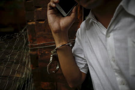 A student activist talks on a phone as he arrives at a mass trial of student protesters at Tharrawaddy court, Tharrawaddy, Bago division July 28, 2015. REUTERS/Soe Zeya Tun