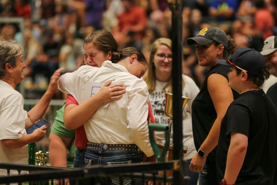 Kennedy Gould celebrates with her family after being named the 2022's 4-H Supreme Livestock Showmanship champion, Thursday, July 21, 2022, at the Tippecanoe County 4-H Fairgrounds in Lafayette, Ind.