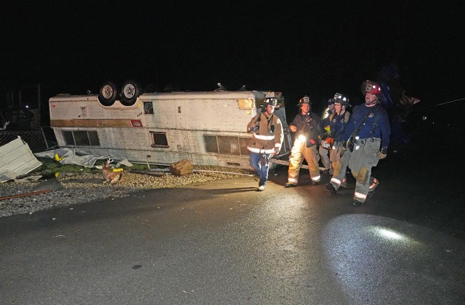 Firemen from the Marysville Fire Department walk through a trailer park after tornadoes ripped through the Indian Lake area of Logan County, Ohio, late Thursday, March 14, 2024.