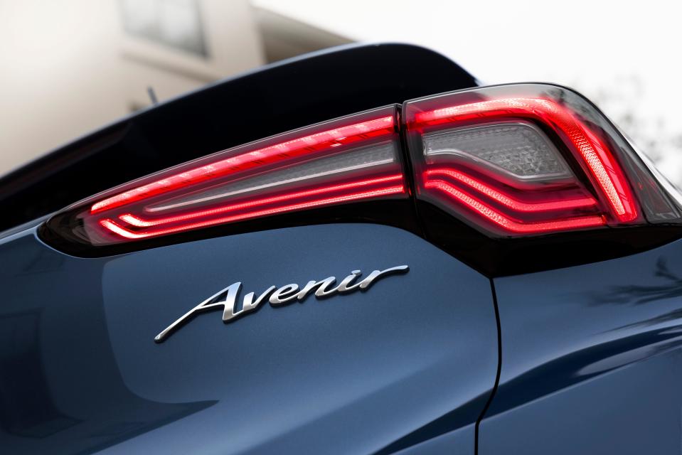 A close-up view of the passenger side taillight and Avenir badging on the 2024 Buick Encore GX Avenir in Ocean Blue Metallic. Preproduction model shown. Actual production model may vary. Available in spring 2023.