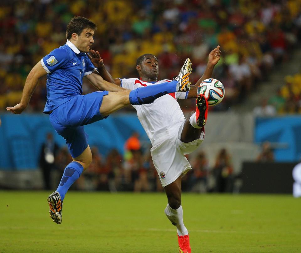 Greece's Sokratis Papastathopoulos (L) fights for the ball with Costa Rica's Joel Campbell during their 2014 World Cup round of 16 game at the Pernambuco arena in Recife June 29, 2014. REUTERS/Brian Snyder