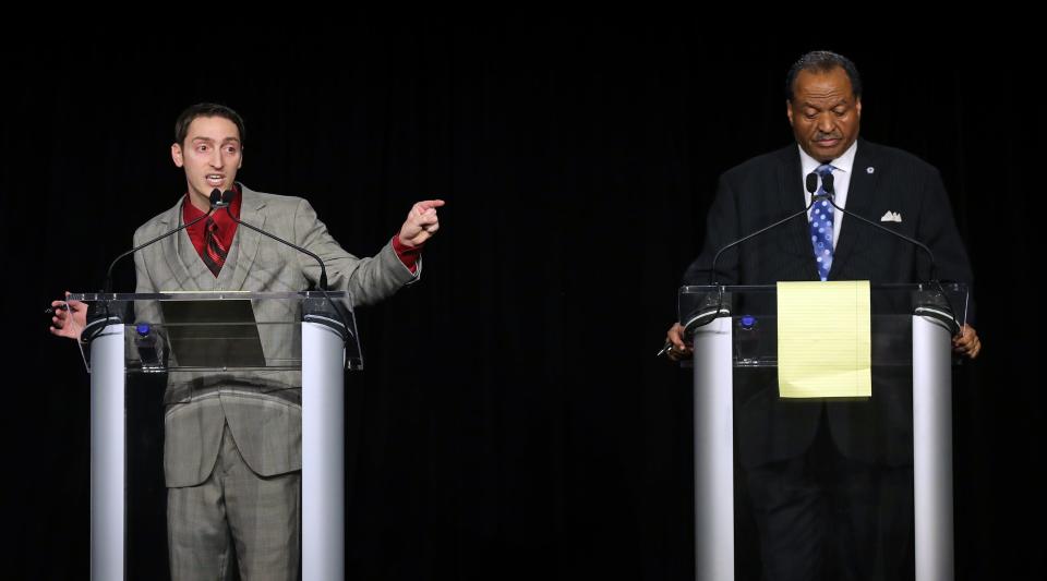 Akron mayoral candidate Joshua Schaffer, left, calls out fellow candidate Marco Sommerville for what Schaffer says are tax breaks to wealthy people instead of to low income people Wednesday during the Akron Decides: Debating the Future mayoral debate.