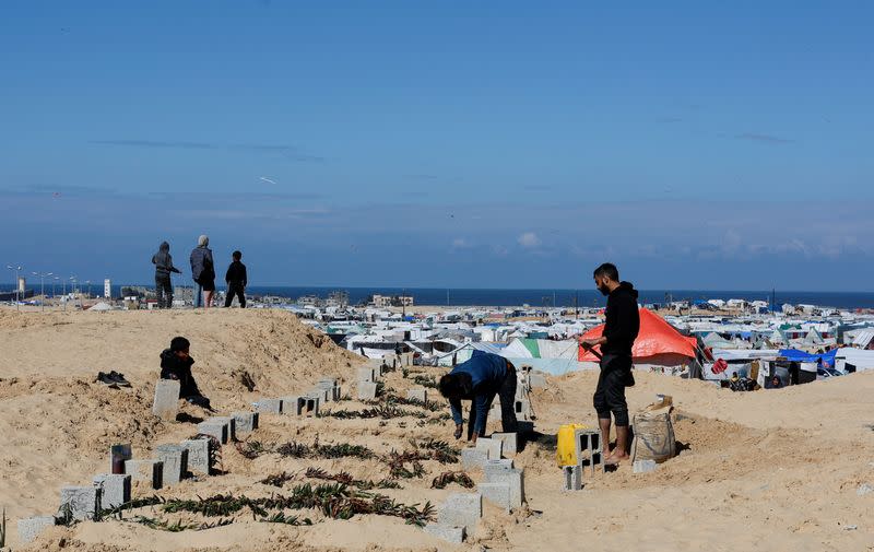 Displaced Palestinians shelter in a cemetery in Rafah in the southern Gaza Strip