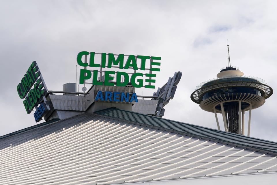 The roof-top sign for Climate Pledge Arena is shown next to the Space Needle ahead of the Seattle Kraken's home opener on Saturday.